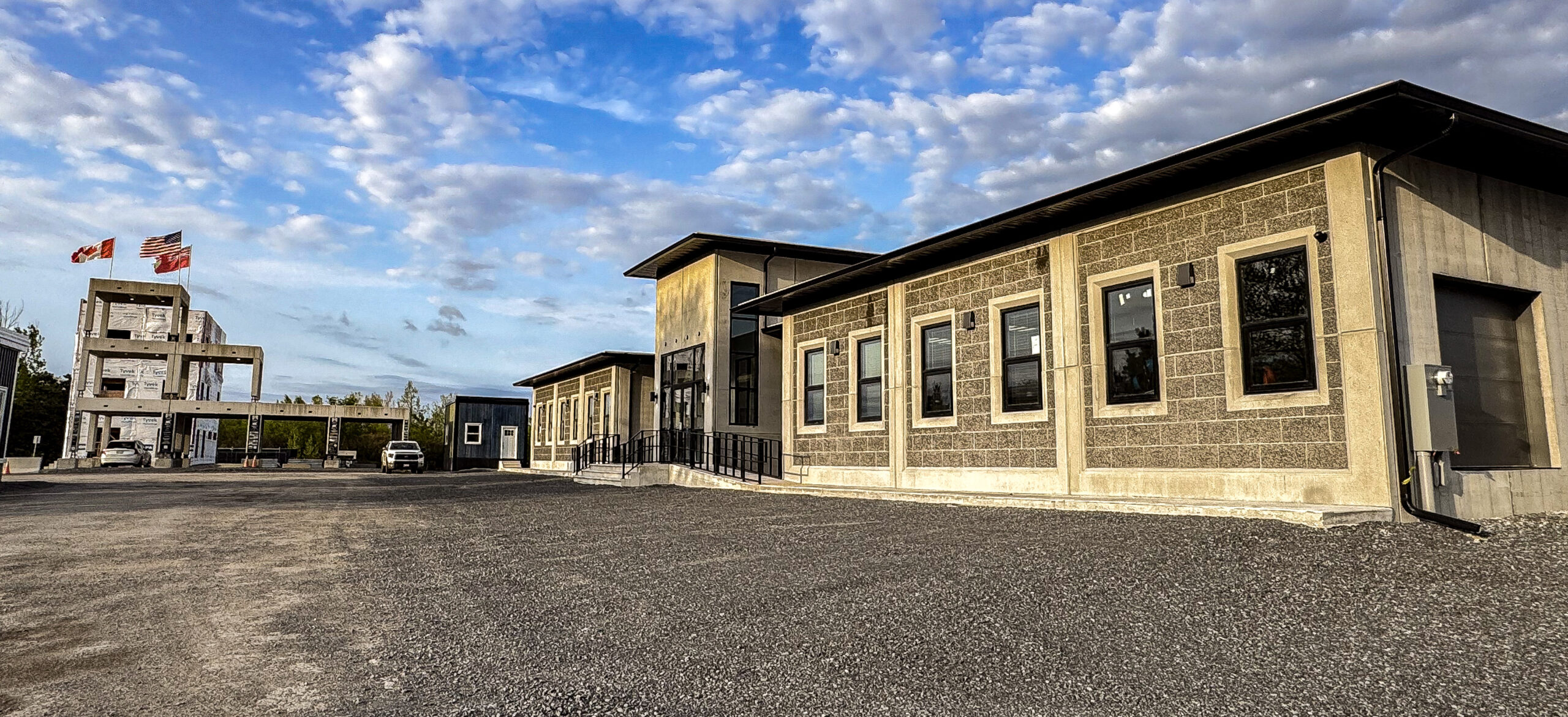 Completed Lodestar office beside an exposed structural frame, showing how a repeatable system supports a distinct architectural result